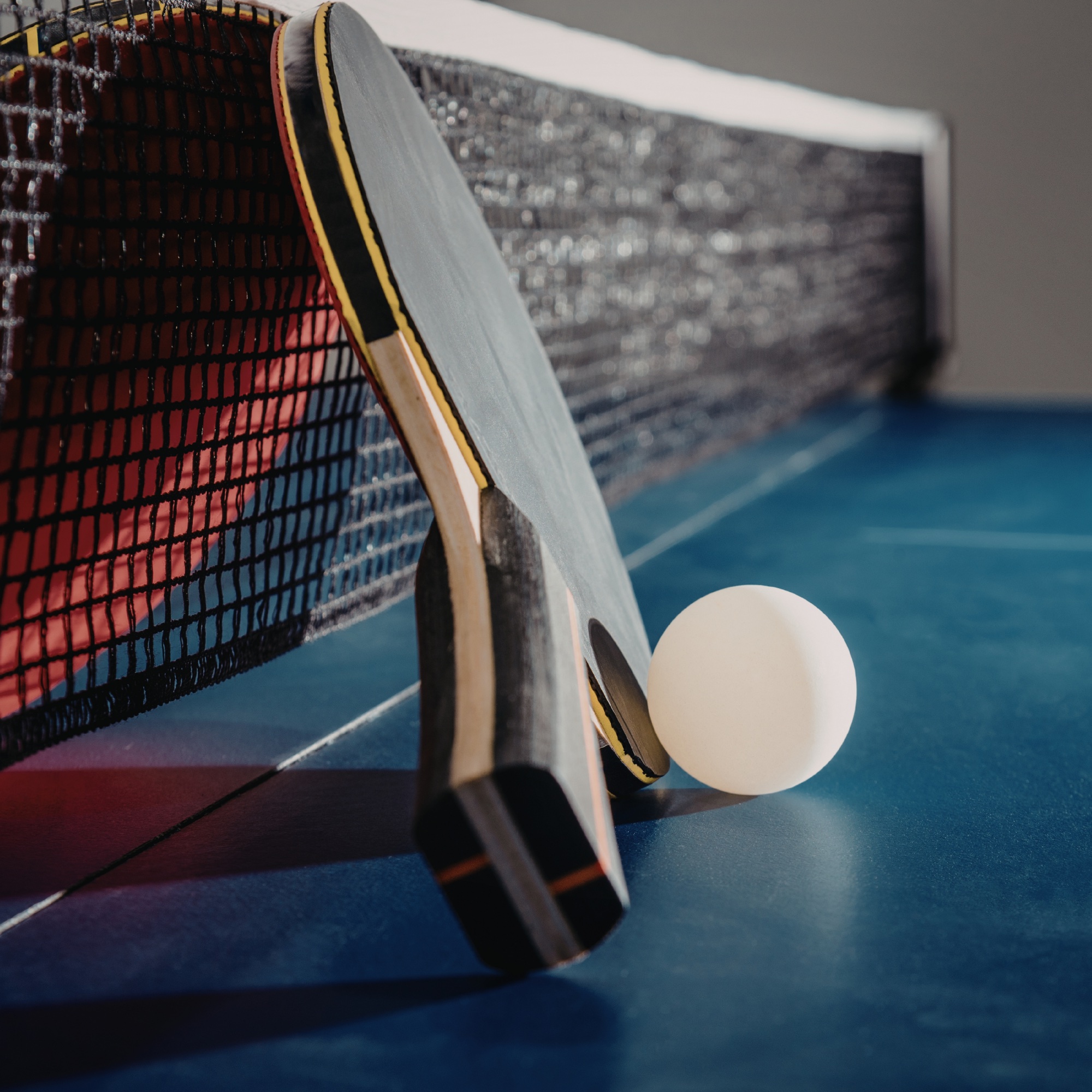 People playing table tennis and chatting together