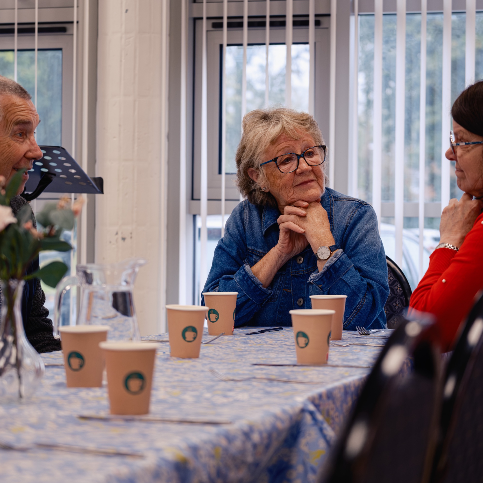 Seniors gathered together over coffee and scones